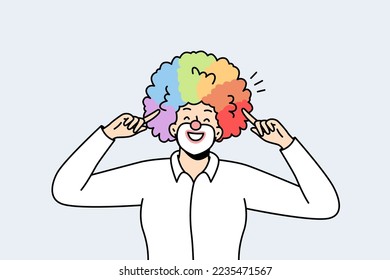 Portrait of male clown pointing with index fingers at his voluminous multicolored hairstyle, wig. LGBT smiling man with rainbow hairs. Gay pride. Front view. Vector minimalistic modern design.