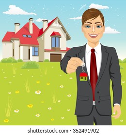 portrait of real estate agent holding the key of a new house
