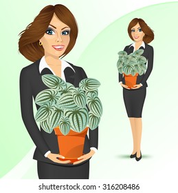 portrait of smiling business woman holding peperomia marmorata plant in a pot isolated on white background 
