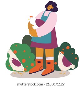 portrait of a smiling female poultry farmer and her chickens