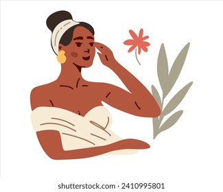 Portrait of a young and beautiful African American woman doing facial massage, self-care, skin care cosmetics