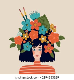 Portrait of the young beautiful  woman artist with a crown of flowers and brushes.