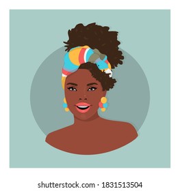 Portrait of a young black woman with a colorful head band and big earnings, smiling 