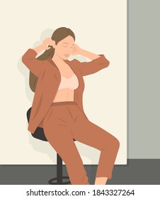 Portrait of young Caucasian woman posing in shirt and blue jeans, sitting on stool in white studio