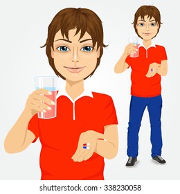 portrait of young handsome man taking pills with glass of water