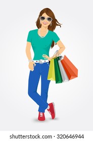 portrait of young smiling pretty woman holding shopping bags isolated on white background