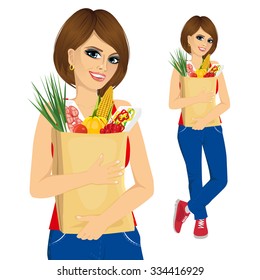 portrait of young woman carrying grocery paper bag full of healthy vegetables and other food