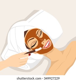 portrait of young woman having chocolate mask treatment therapy lying down on massage bed