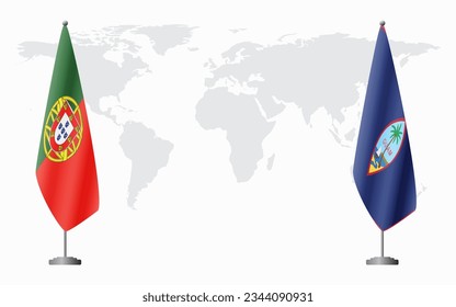 Portugal and Guam flags for official meeting against background of world map.