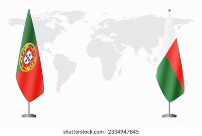 Portugal and Madagascar flags for official meeting against background of world map.