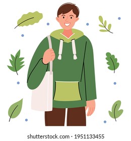 Positive guy in a modern green sweater with an eco bag. Ecological lifestyle.
