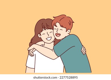 Positive little boy and girl hugging and laughing enjoying spending time together or summer vacation. Concept of happy childhood and friendship between classmates or little brother and sister 