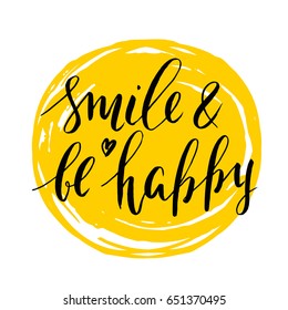 Positive quote brush lettering. Modern calligraphy. Typography. Handwritten ink inscription: smile and be happy. Heart. Vector card. Yellow sun.