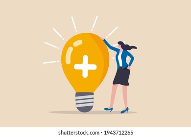 Positive Thinking, Optimistic Bring Success To Work And Living, Inspiration And Happiness In Work Concept, Cheerful Businesswoman Standing With Bright Lightbulb Idea With Positive Sign.