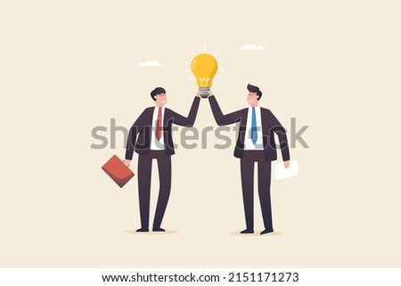 Positive thinking team, brainstorm idea concept, creativity and imagination for Business. Two colleagues hold a light bulb to compare the discovery of a new idea.