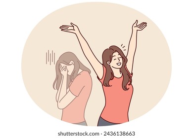 Positive woman raises hands up and rejoices having got rid of bad emotions and depression spoiling mood. Crying doppelganger behind girl for concept of mood swings or split personality