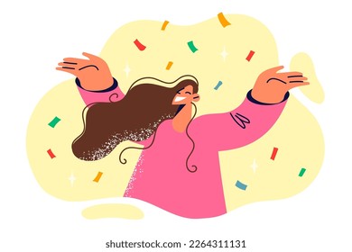 Positive woman raising hands rejoicing with festive confetti during birthday or christmas eve holiday party. Lady dances at party and smiles broadly while standing among falling paper salute 