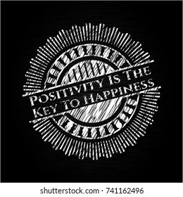 Positivity Is The Key To Happiness written on a chalkboard