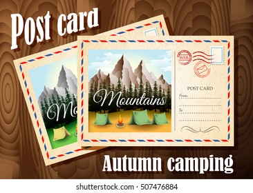 Post card design. Autumn camping post card and summer camping post card are on the wood table background. Autumn in the mountains.