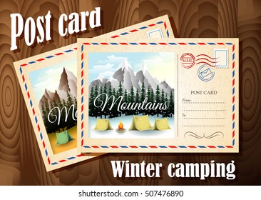 Post card design. Winter camping post card and autumn camping post card are on the wood table background. Winter in the mountains.