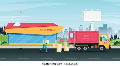The postal staff is carrying the parcel box to the truck.