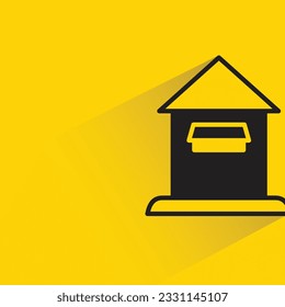 postbox with shadow on yellow background