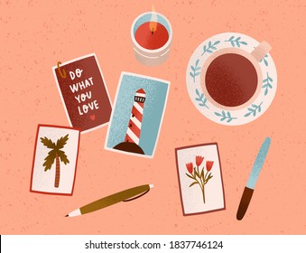 Postcard collecting. Cozy hygge home composition with motivational cards. Desk with a candle, cup of tea or coffee, pictures and pen. Colorful flat vector cartoon top view illustration