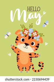 Postcard Hello May. Cute tiger cub with flower wreath on its head and butterflies. Vector illustration. Spring May card with tiger character for design, decor, postcards and print, Kids collection