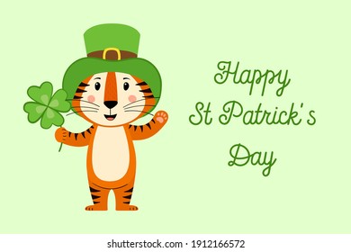 A postcard template with a cute tiger, the symbol of the year 2022 in the Chinese calendar. Handwritten text of "Happy St. Patrick's Day". Vector stock illustration.