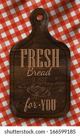 Poster with brown wood cutting board lettering fresh bread for you on a red checkered tablecloth.