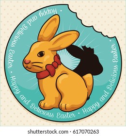 Poster with a chocolate bunny in golden package and ribbon over a half eaten rabbit and label to celebrate Easter season.
