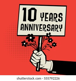 Poster in hand, business concept with text 10 years anniversary, vector illustration.