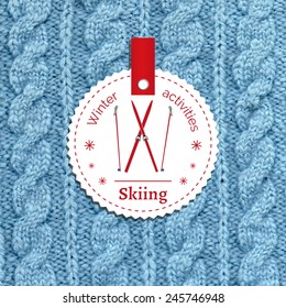 Poster for a winter activity. Motto, slogan for winter season.  Skiing as a winter pleasure. Emblem for winter poster with skis. Knitted wool background. Winter banner. 