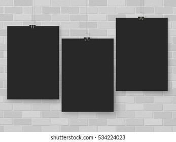Posters on binder clips on brick wall. Rectangular black paper mock up. Modern vertical framings for your design. Vector blackboard template for lettering, drawing, presentations or quotes.