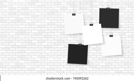 Posters on binder clips. Paper templates on brick wall. Realistic mock up. Empty notepad sheet for your business design. Brick wall. Vector templates for lettering, quote, images or logos.