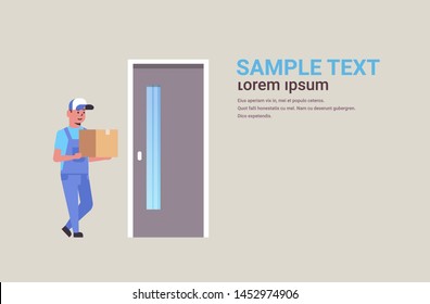 postman in uniform holding cardboard parcel box at door courier home express delivery service concept flat full length horizontal copy space