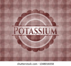 Potassium red emblem or badge with abstract geometric polygonal pattern background. Seamless.