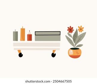 The potted home flower and tea table with decorative candles and box