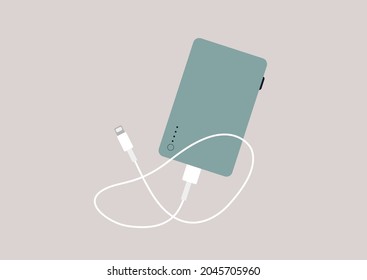 A power bank device with a mobile phone charging cable isolated on a plain background