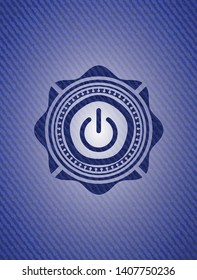 power icon inside badge with denim background