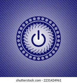 power icon inside emblem with denim texture. 