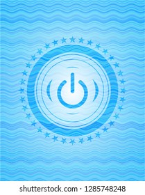 power icon inside water representation emblem.