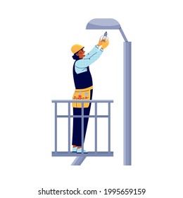 Power lineman or electric repairman replaces bulb on street lighting post, flat vector illustration isolated on white background. Electrician worker repairing light.
