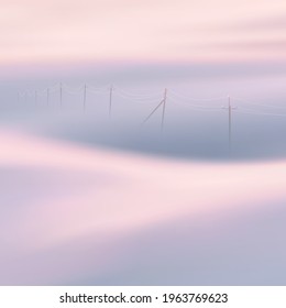 Power lines. Foggy clouds. Pastel fog waves. Countryside landscape