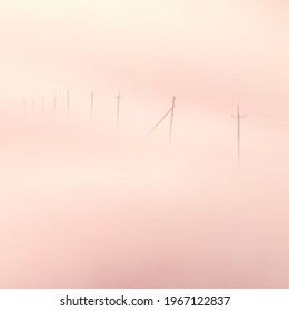 Power lines. Foggy clouds. Pastel fog waves. Countryside landscape