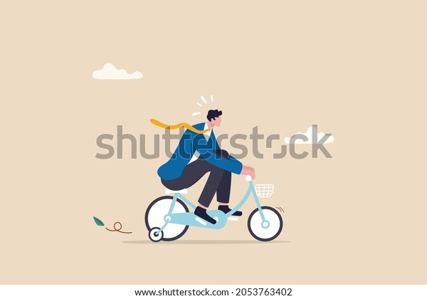 Practice, training or effort for career growth or\
business success, entrepreneur, amateur begin or start new business\
concept, newcomer businessman practice riding child bicycle with\
training wheels. 