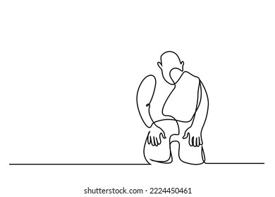 praying man sitting on the floor looking down
