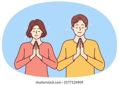 Praying man and woman fold palms in front of chests for joint prayer and religious ritual. Religious areni and girl with smile pray to god asking almighty for help in solving problems