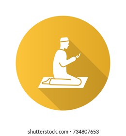 Praying muslim man flat design long shadow glyph icon. Worship. Islamic culture. Vector silhouette illustration