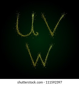 Precious capital letters U V W spraying script font with gold sand. Golden fantasy sparking initial on dark shiny background